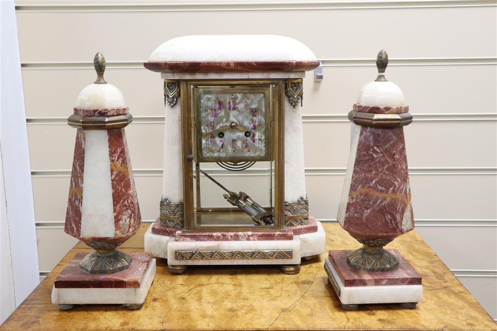 An Art Deco rouge and white marble clock garniture